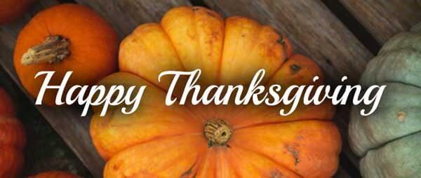 Happy  Thanksgiving written across the top of an orange pumpkin