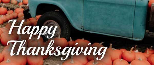 Old truck among pumpkins with the words Happy Thanksgiving,