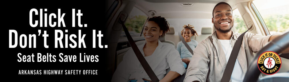 Man, woman, and child buckled up in car with the words 